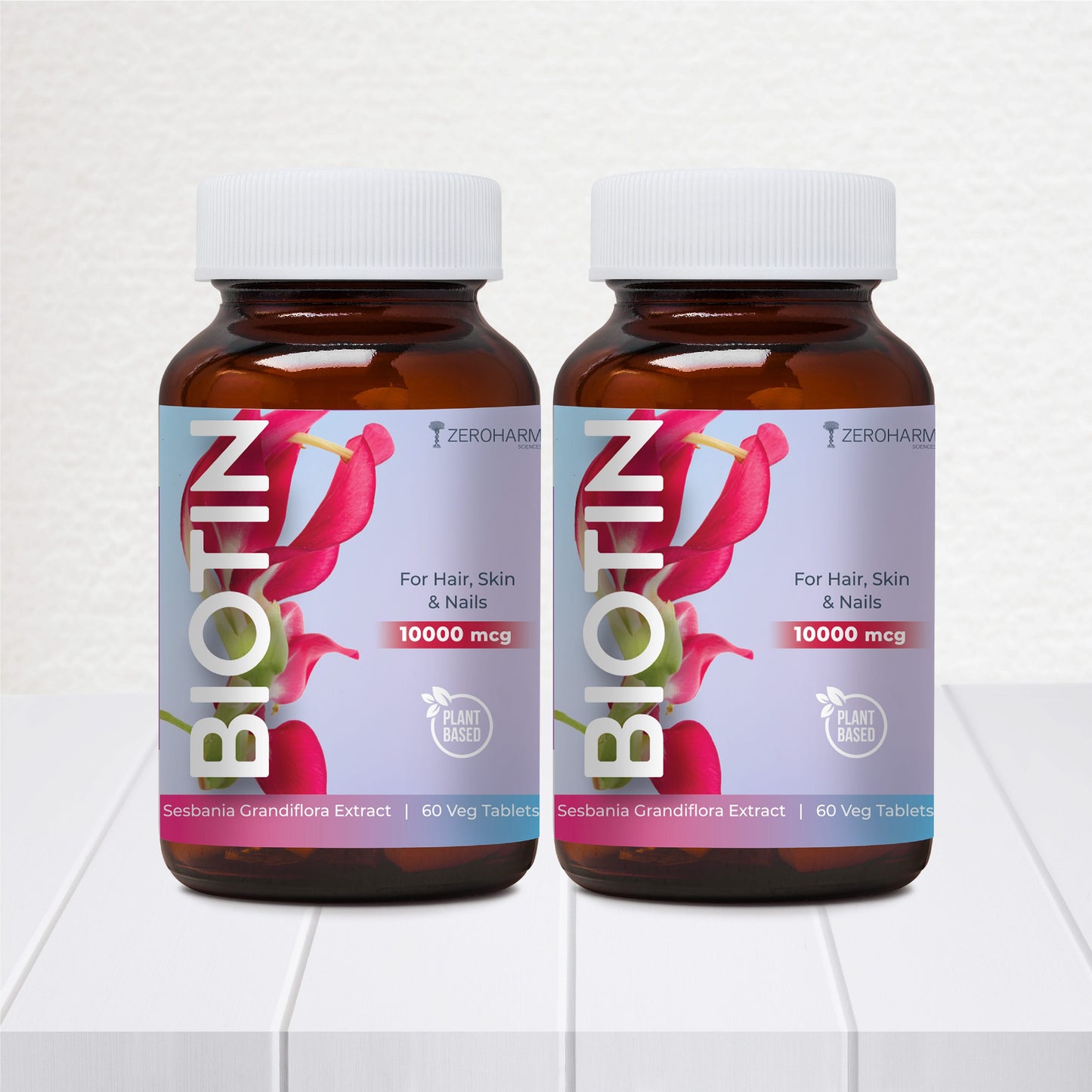ZeroHarm Biotin 10000mcg plant-based tablets for hair, skin and nails, two supplement bottles with pink labels featuring Sesbania grandiflora extract.