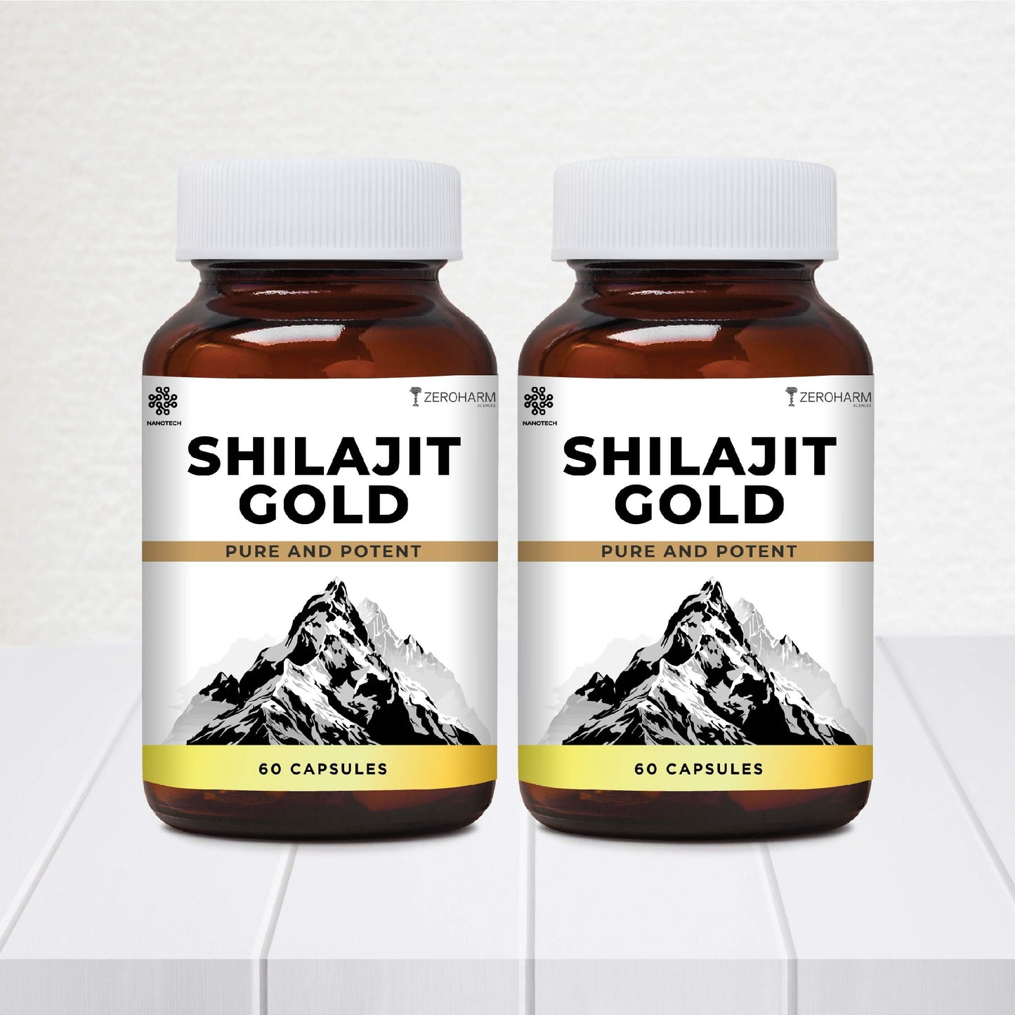 Two brown supplement bottles labeled “Shilajit Gold – Pure and Potent” with white caps are displayed side by side, each featuring a mountain illustration on the label and indicating 60 capsules per bottle.