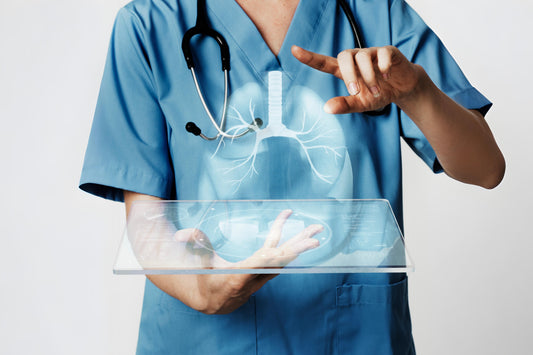An image of a healthcare professional in scrubs using a holographic display to show a 3D model of the lungs, symbolizing advanced medical technology.