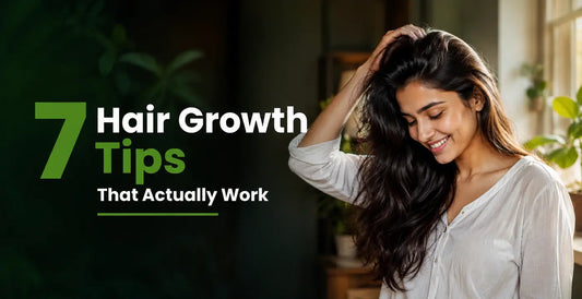 7 proven hair growth tips with an Indian woman smiling while examining her long, healthy hair in a bright home setting.