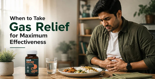 Man holding stomach in discomfort after a meal, with Gas Relief pre+probiotics supplement bottle nearby - when to take it for best results.
