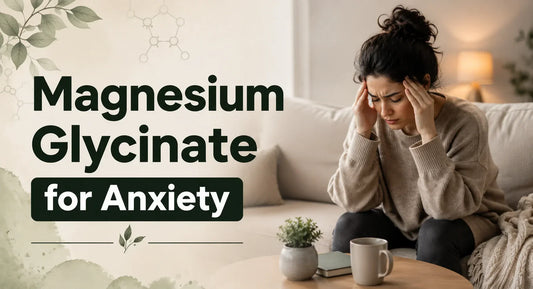 Stressed woman holding her head on sofa with tea and plant on table representing Magnesium Glycinate benefits for anxiety relief