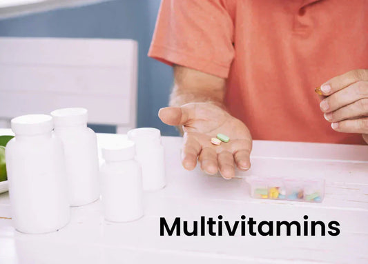 An image of a person holding multivitamin tablets in their hand, with bottles of supplements in the background, emphasizing multivitamins for men over 50.