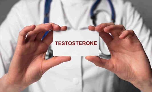 A person in a white lab coat holding a card that reads "TESTOSTERONE" in bold red letters.